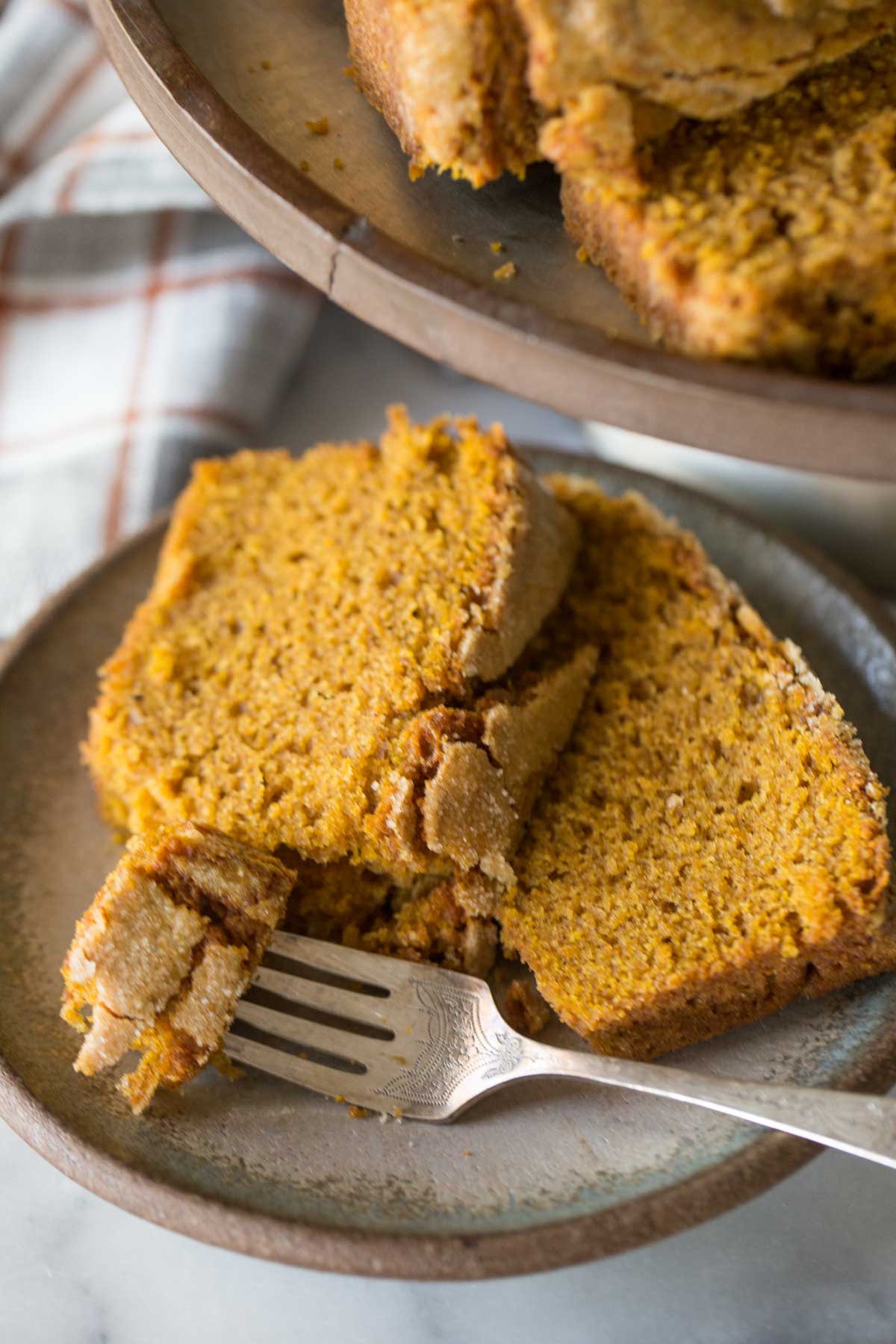Slices of Easy Pumpkin Bread on a metal cake stand. 
