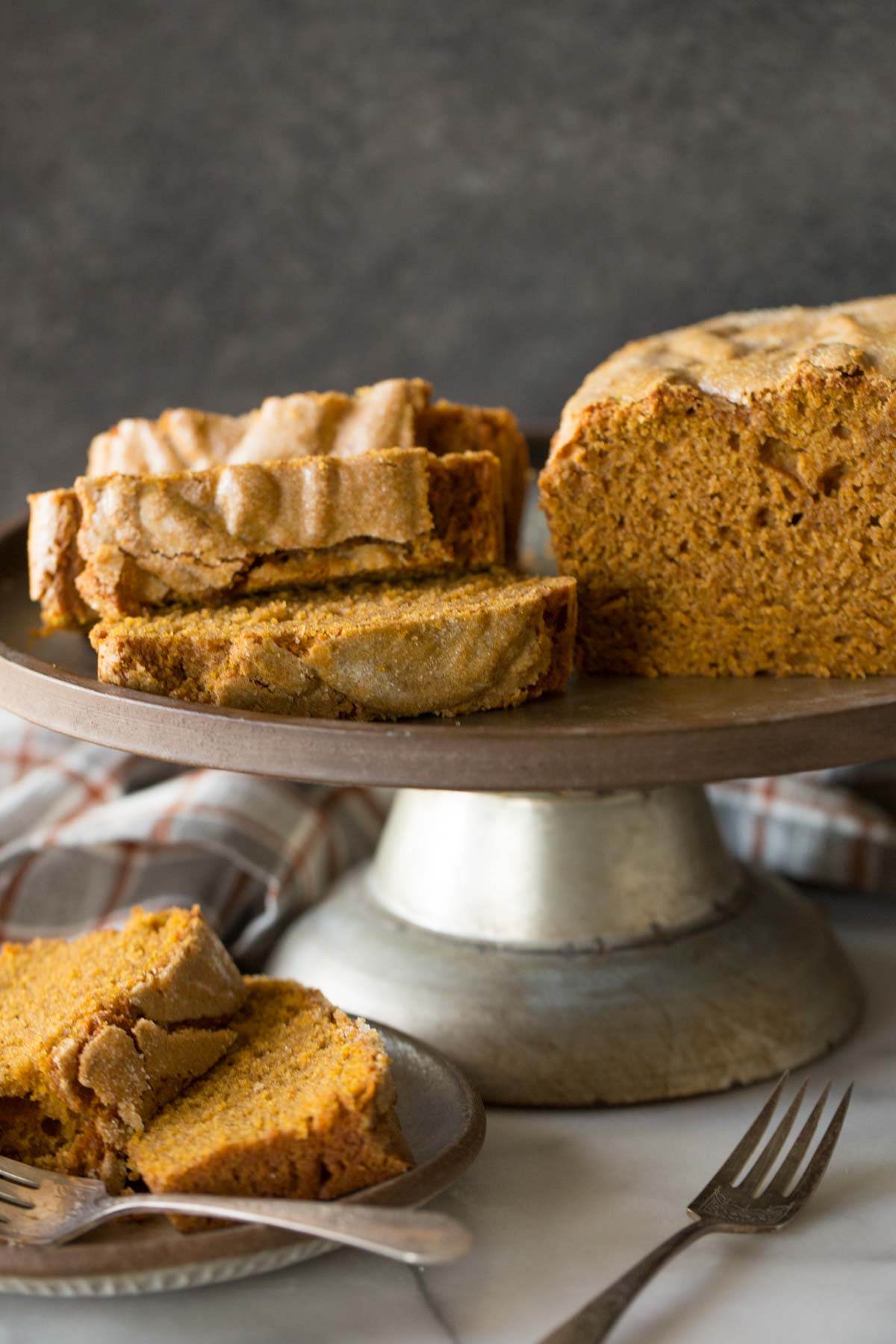Slices of Easy Pumpkin Bread on a metal cake stand. 