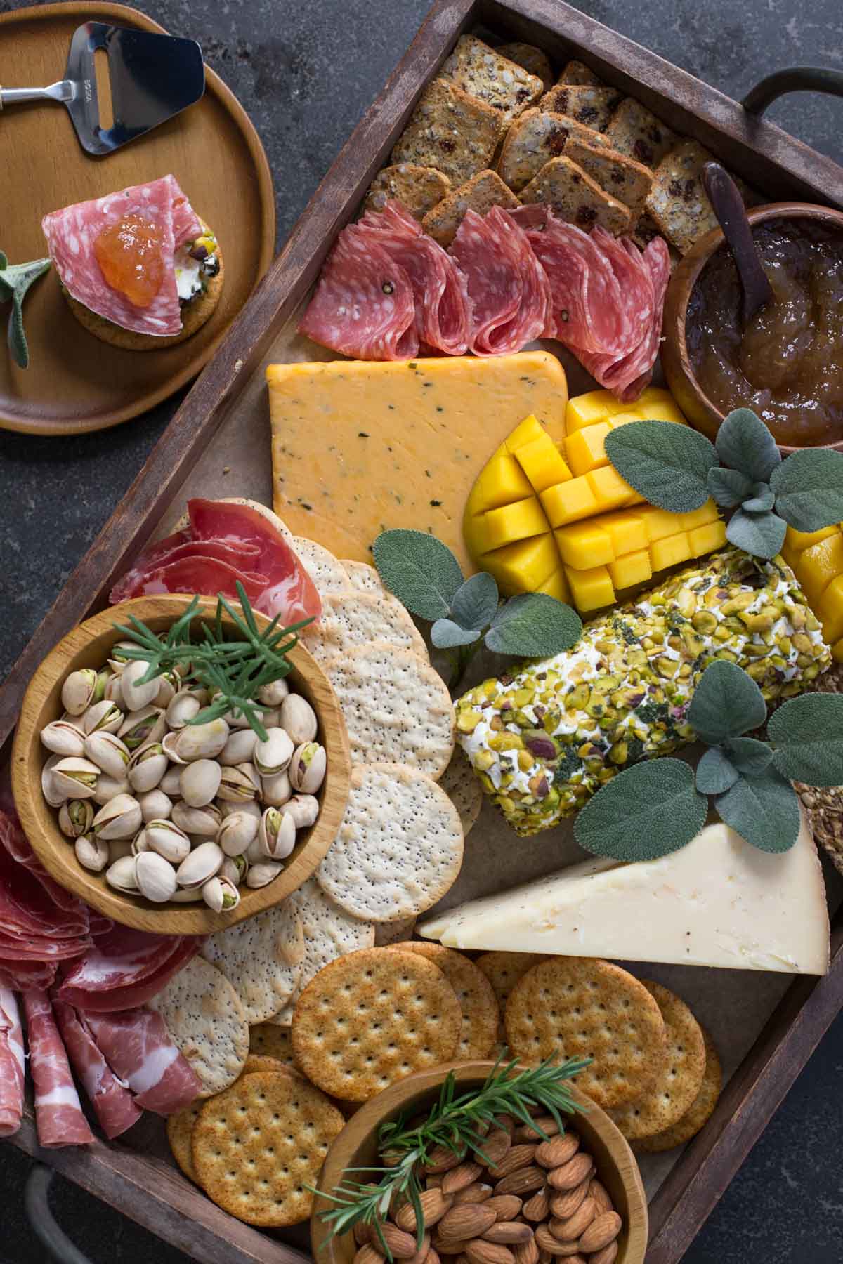 Pistachio Crusted Cheese Log displayed as part of a charcuterie.