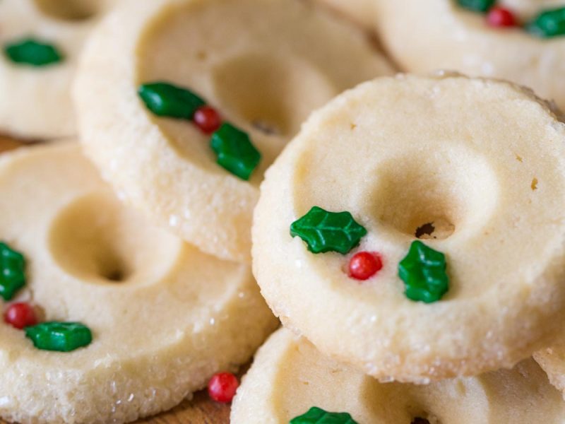 Close up view of Slice and Bake Shortbread Cookies on a wooden plate.