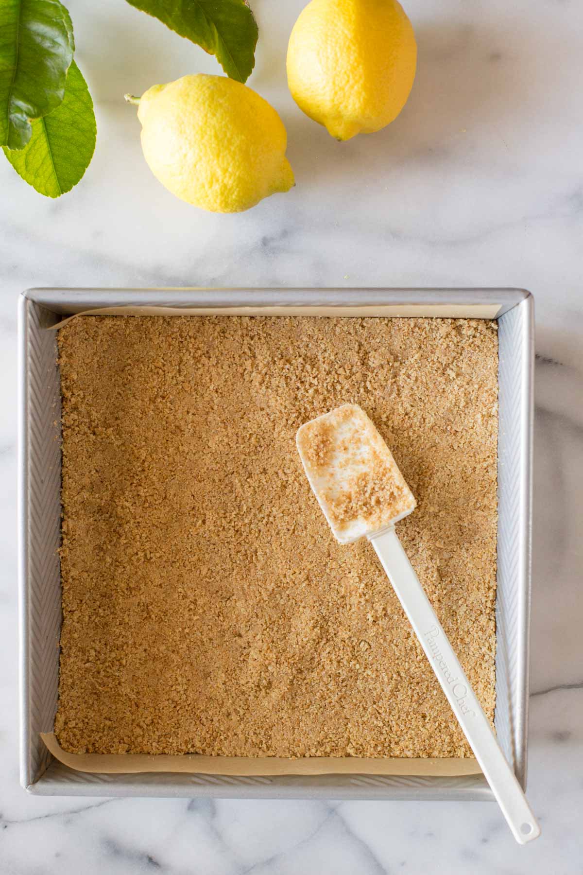 Overhead view of graham cracker crust being made.