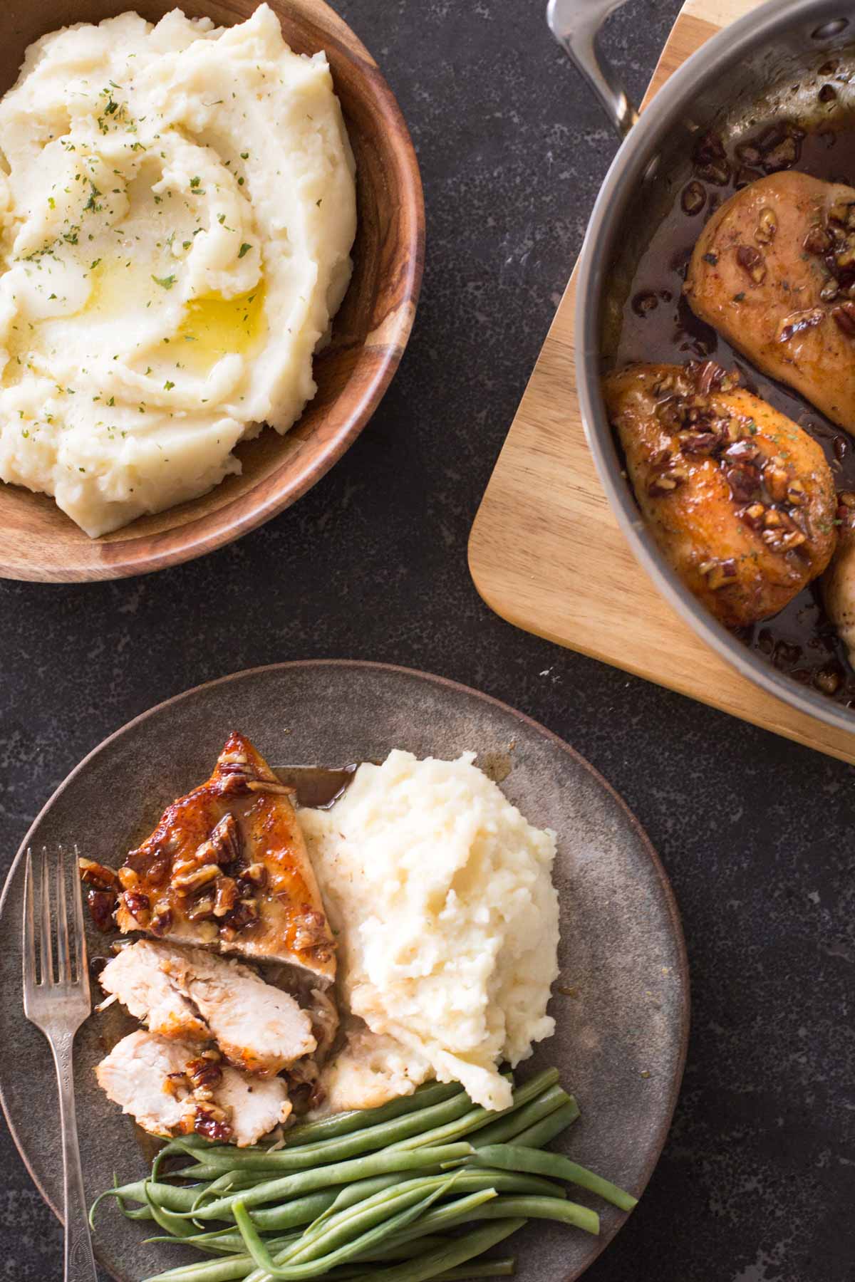 Overhead view of Butter Pecan Chicken dished out onto a plate with a side of mashed potatoes. 