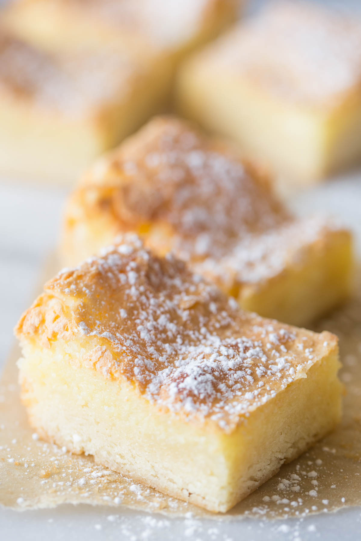 Close up view of Gooey Butter Bars on a white background.