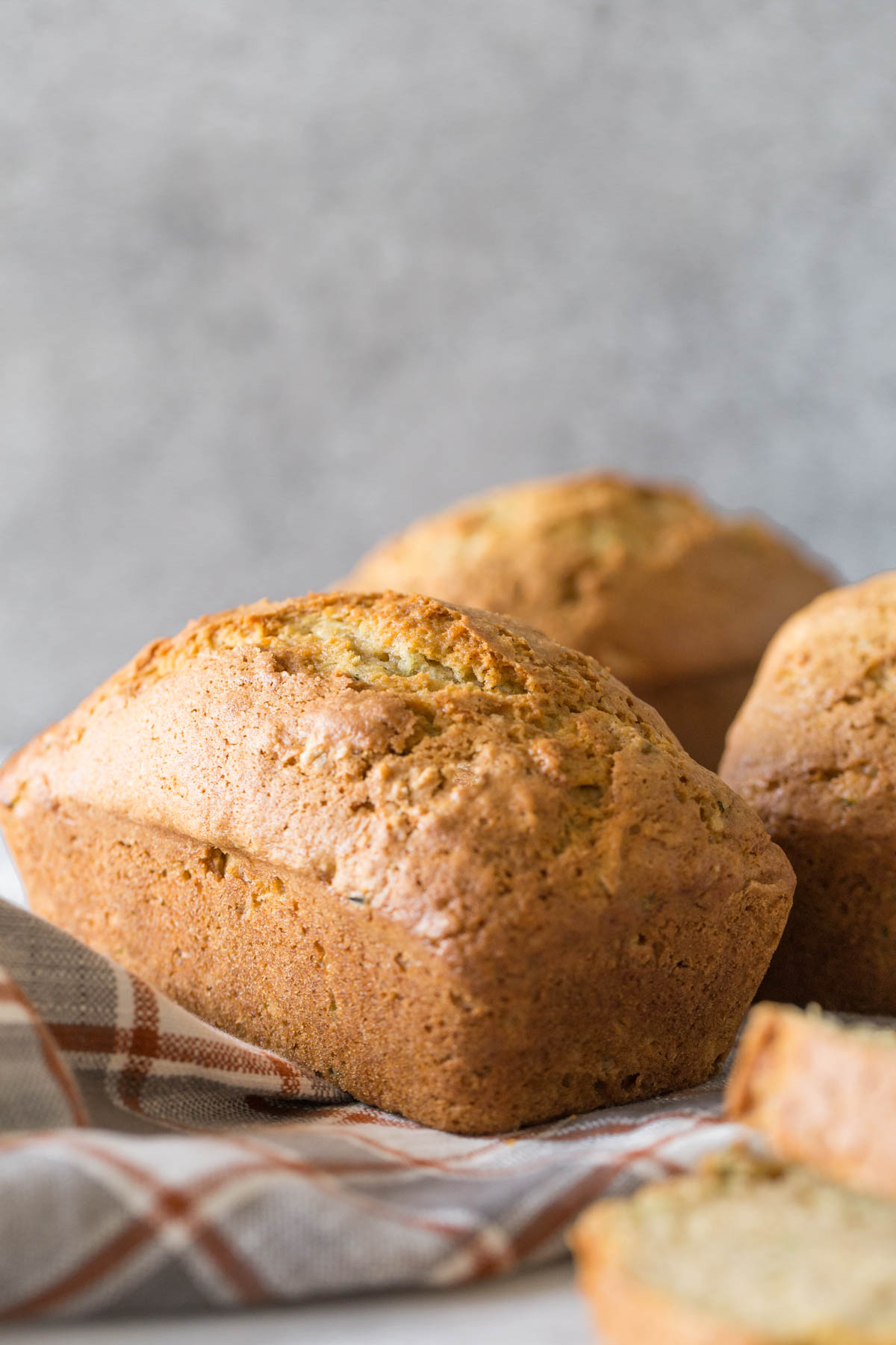 Applesauce Zucchini Bread mini loaf on a grey background.