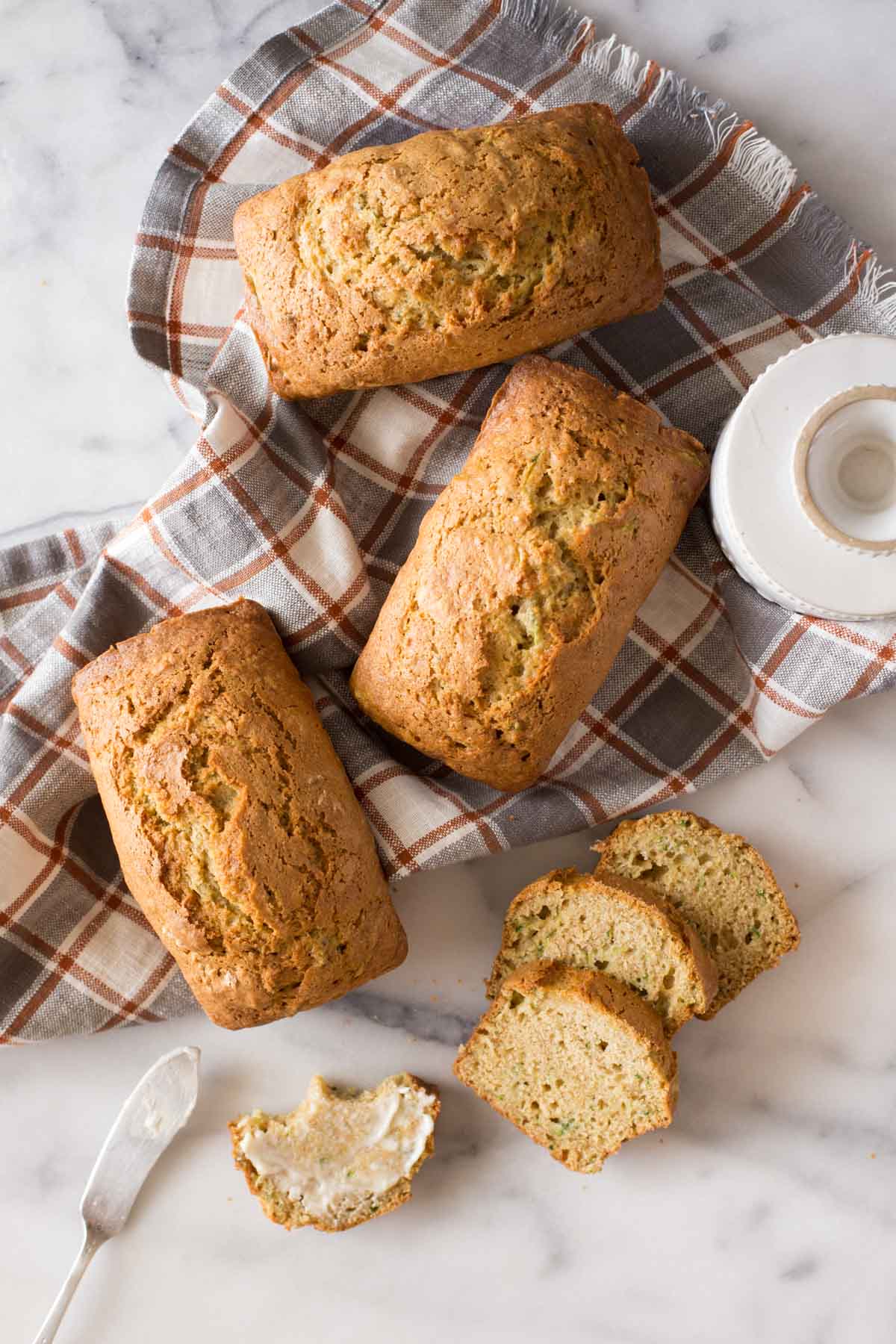 Overhead view of Applesauce Zucchini Bread loaves on a marble board. 
