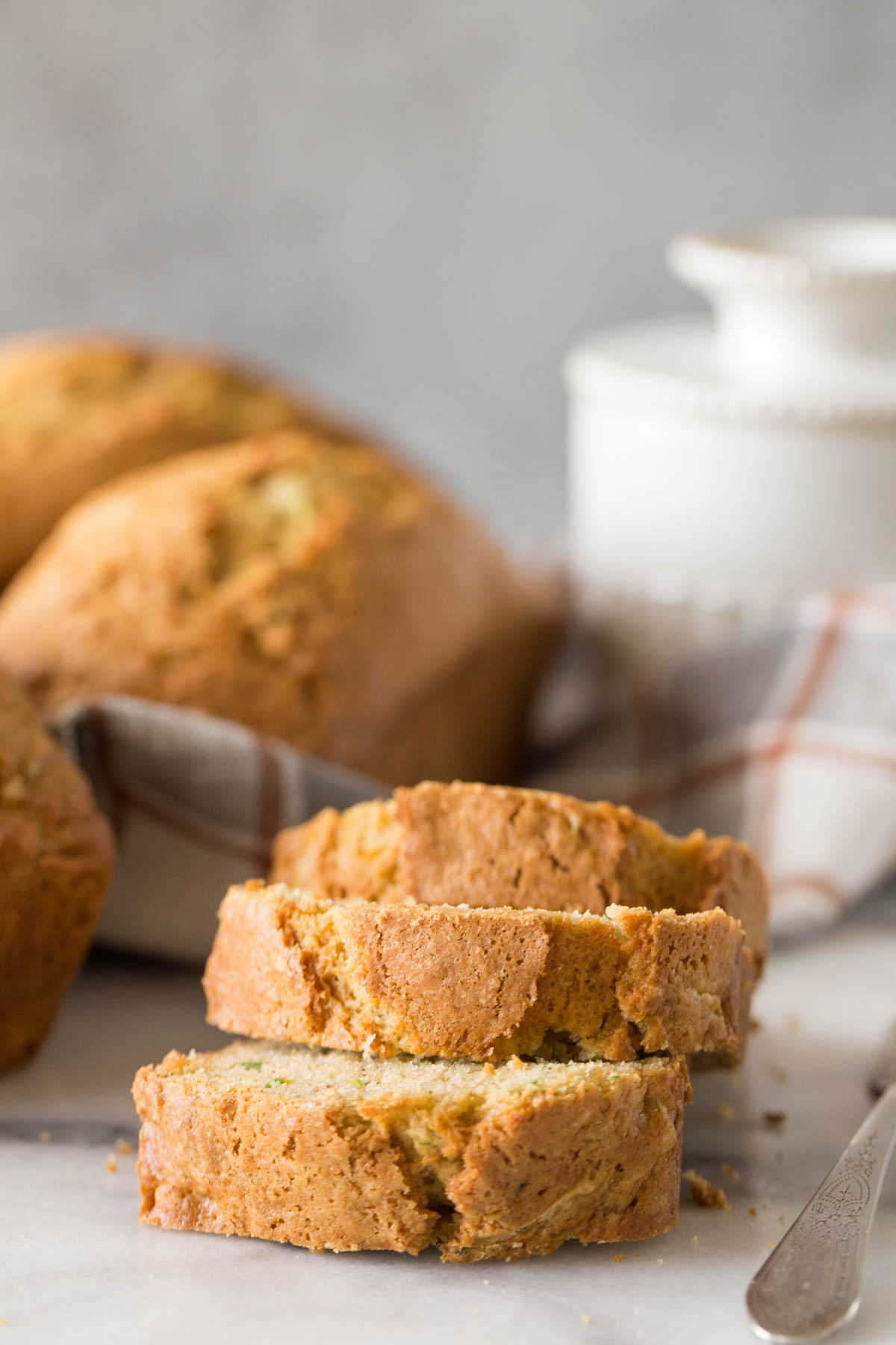 Up close view of sliced Applesauce Zucchini Bread on a marble board. 