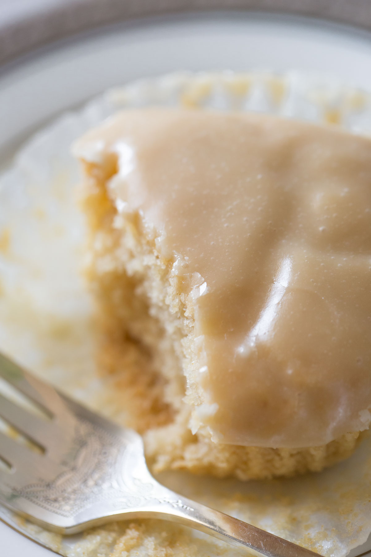 A close up view of a copycat version of Martino's Bakery Tea Cakes on a white plate with a grey background. 