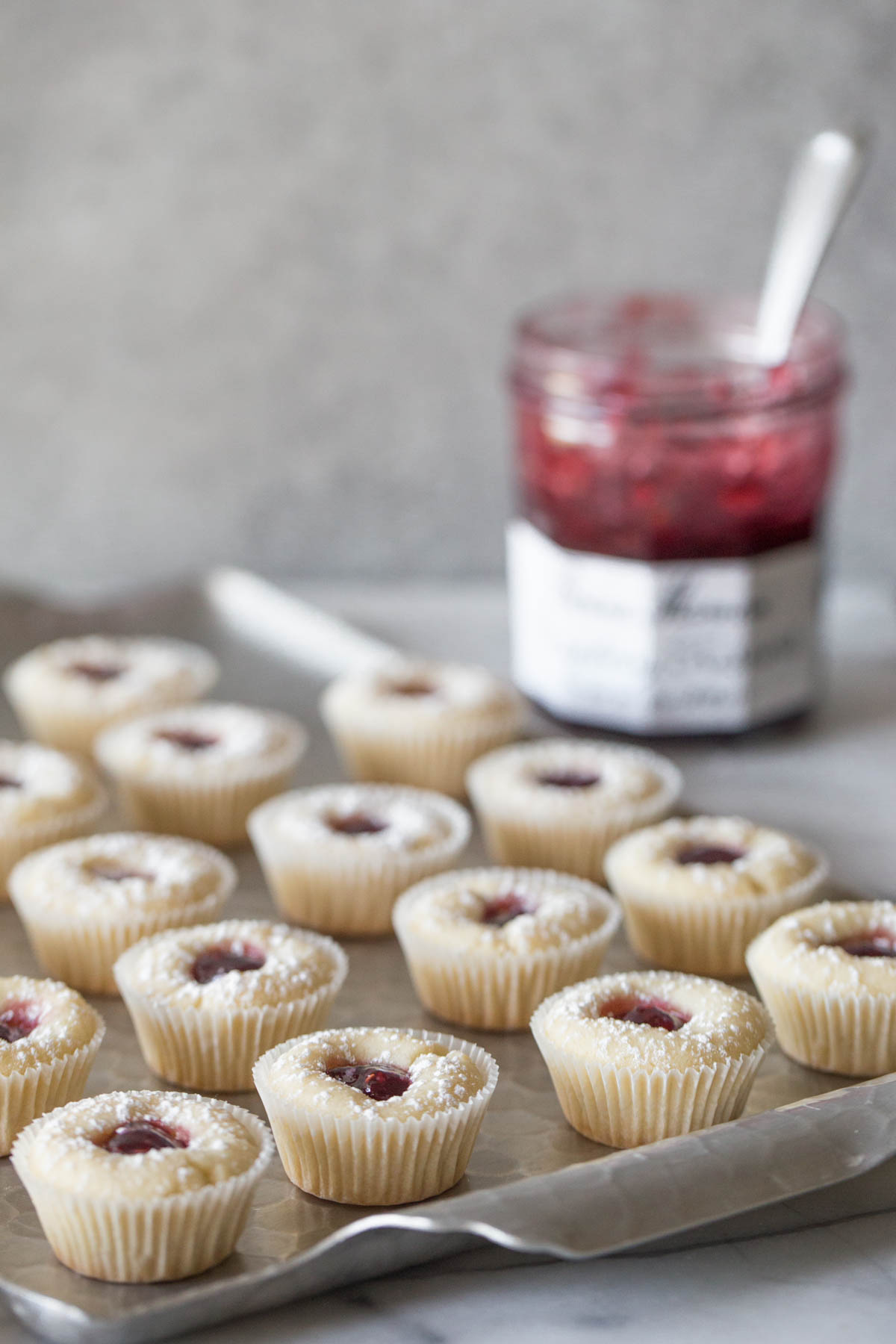 Mini Raspberry Almond Tarts on a sliver tray.