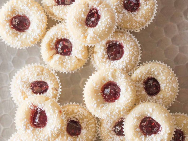 Overhead view of Mini Raspberry Almond Tarts on a sliver tray.