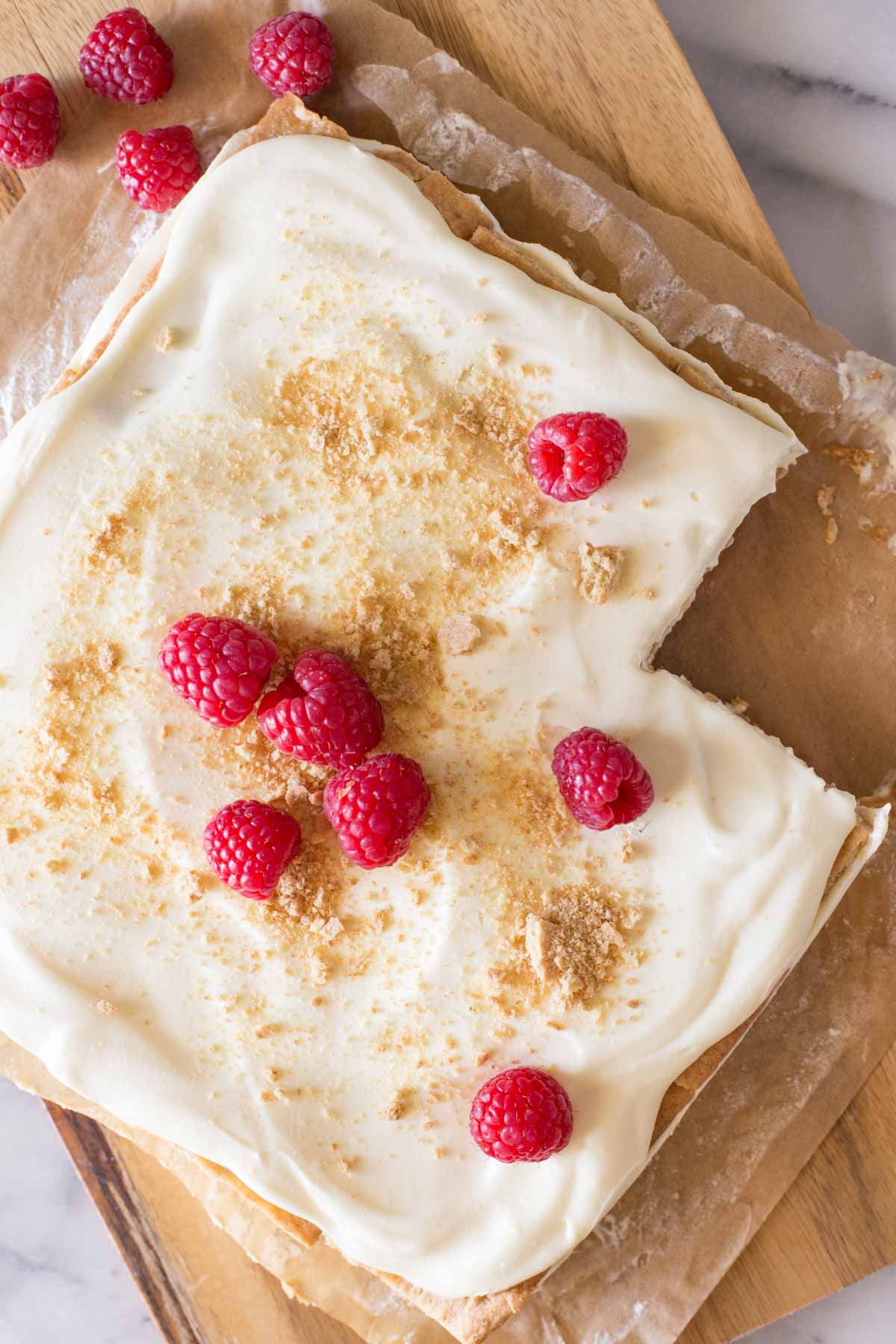 Overhead view of Raspberry Icebox Cake with one piece missing.  