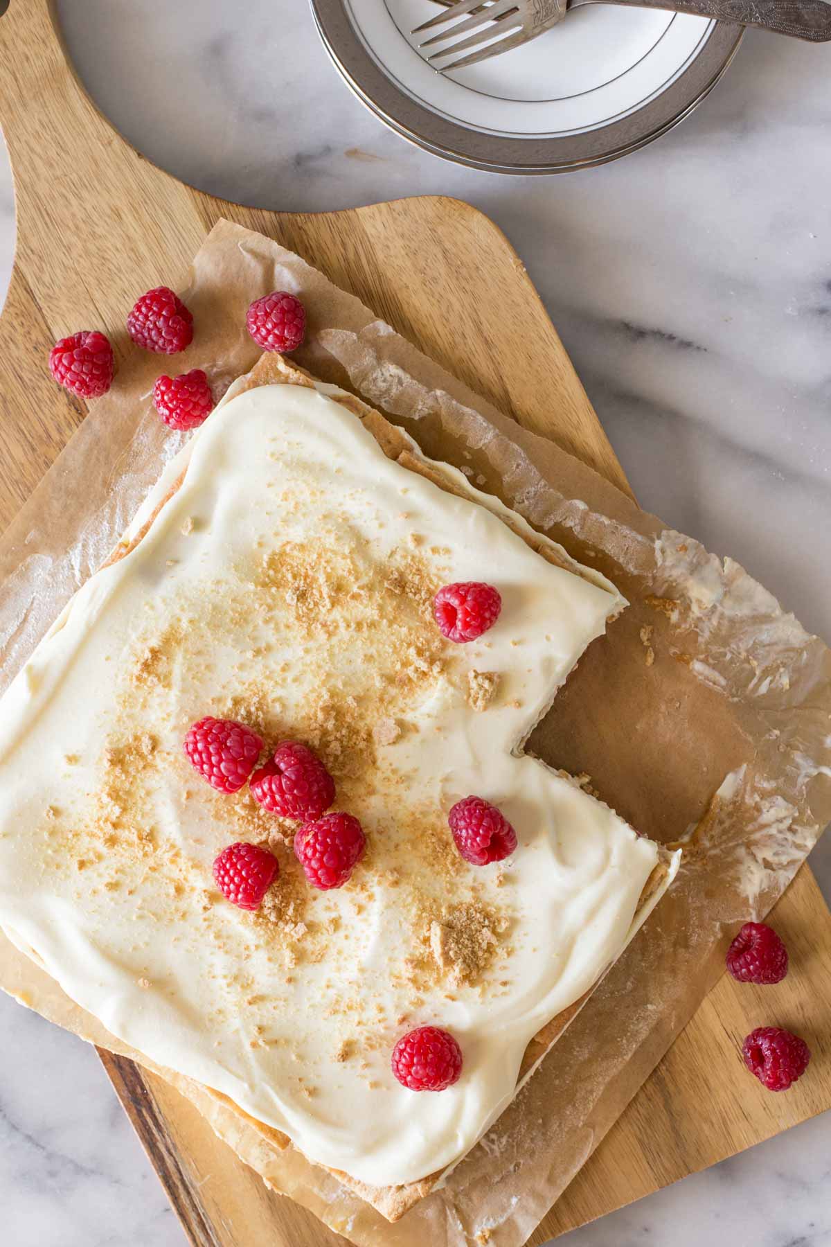 Overhead view of Raspberry Icebox Cake with one piece missing.  