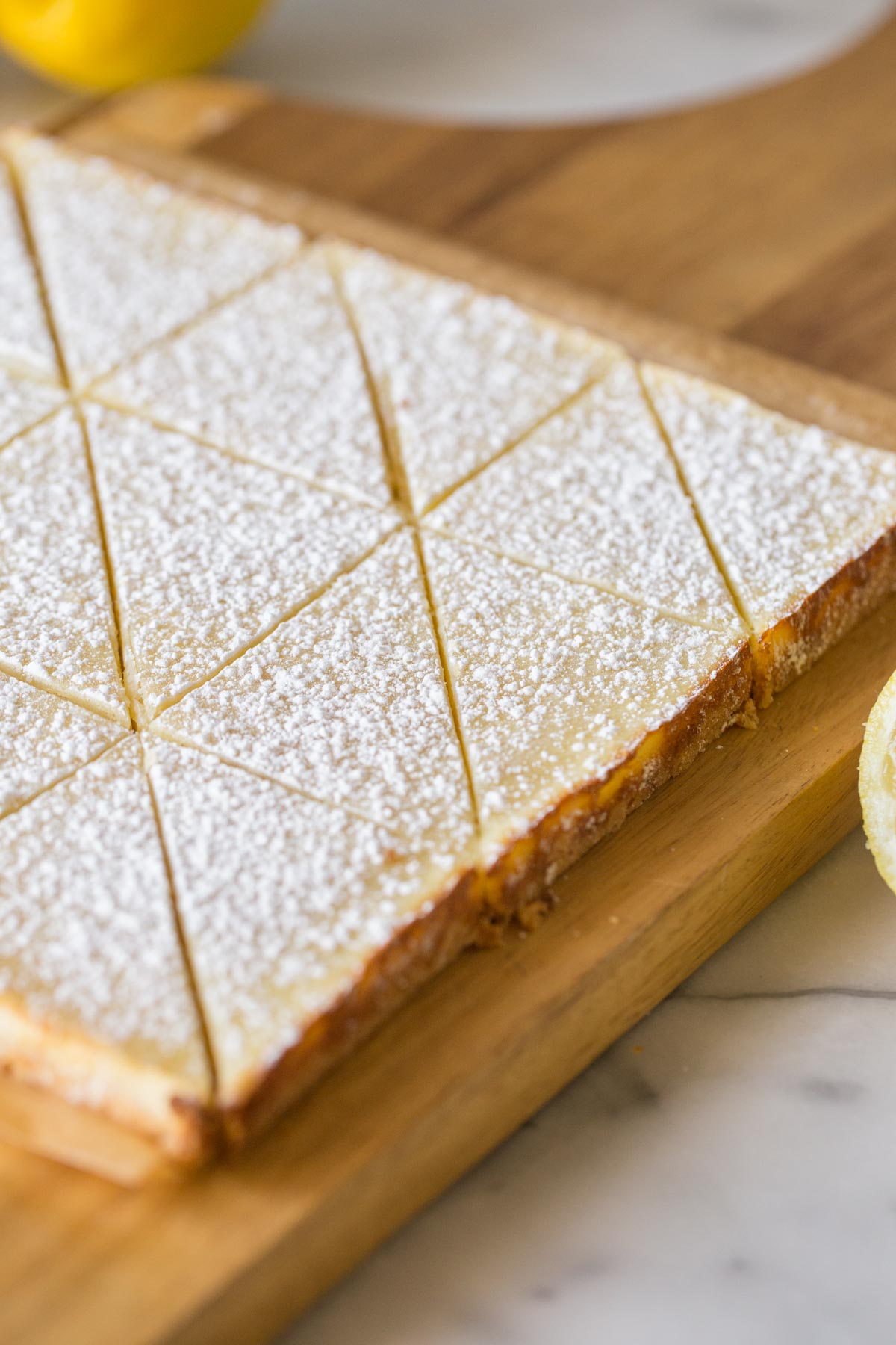 Swedish Lemon Bars on a wooden cutting board.