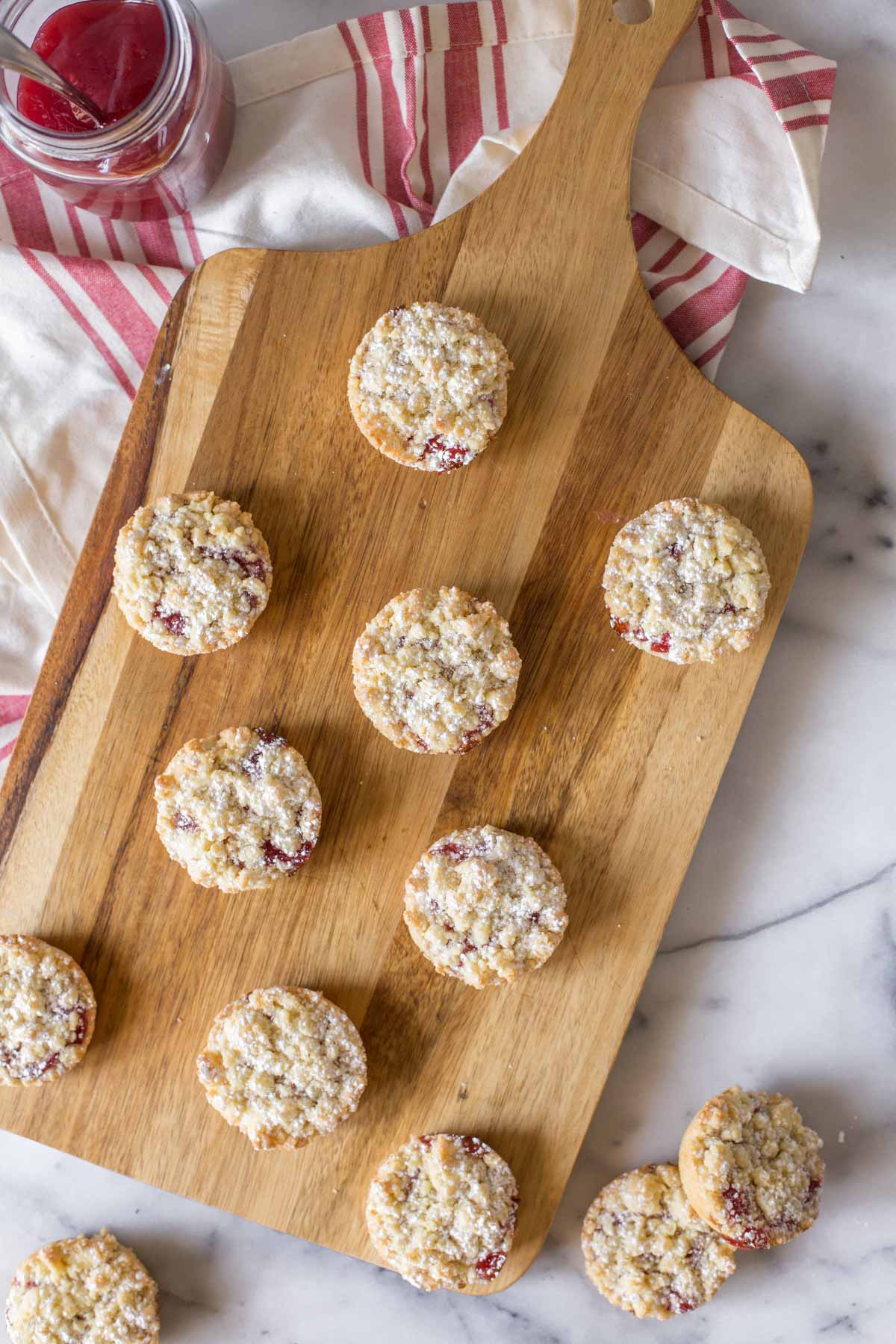 Overhead shot of Costco Raspberry Crumble Cookies on a wooden cutting board.  