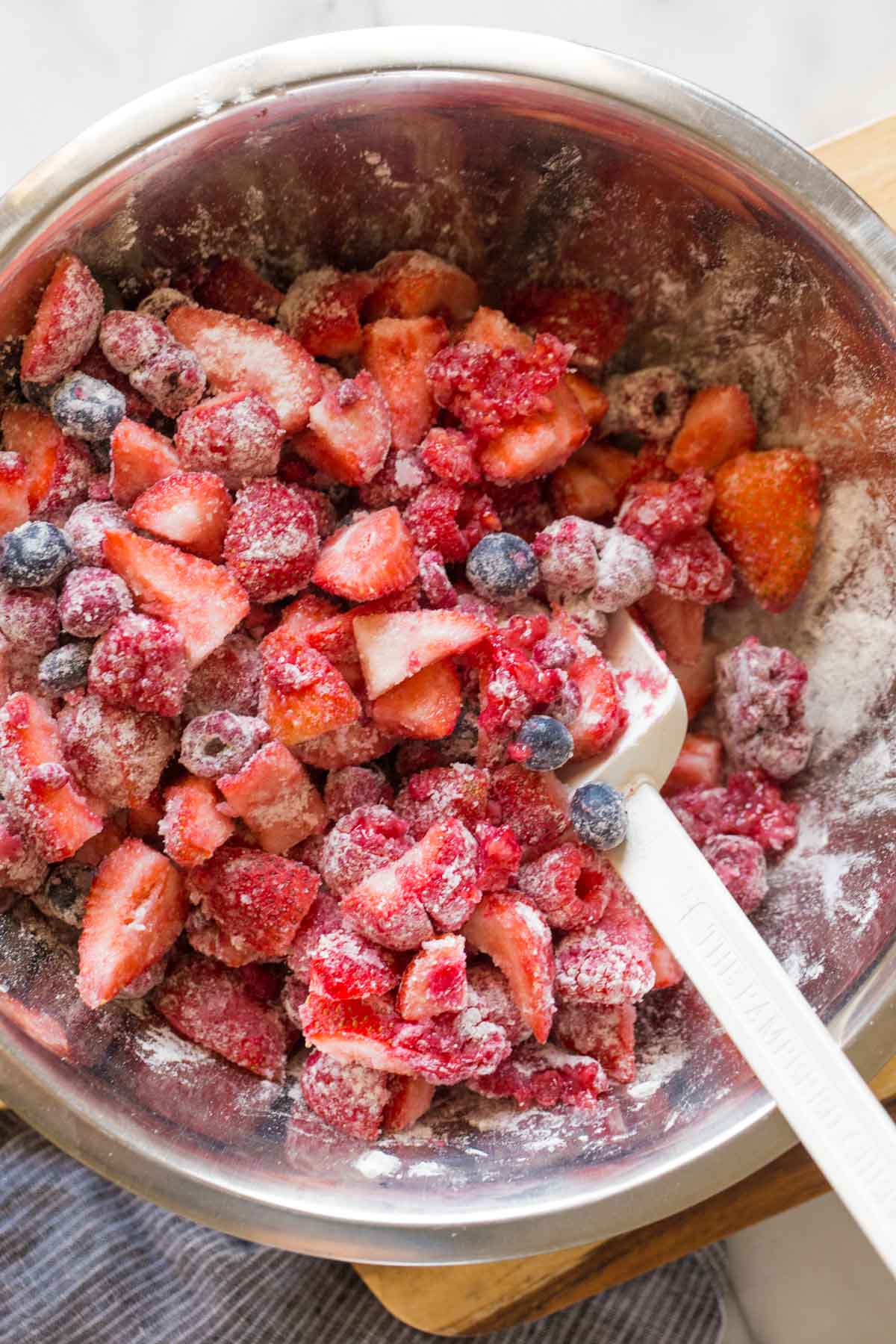 Overhead shot of the berry mixture for the Triple Berry Cobbler in a mixing bowl.  