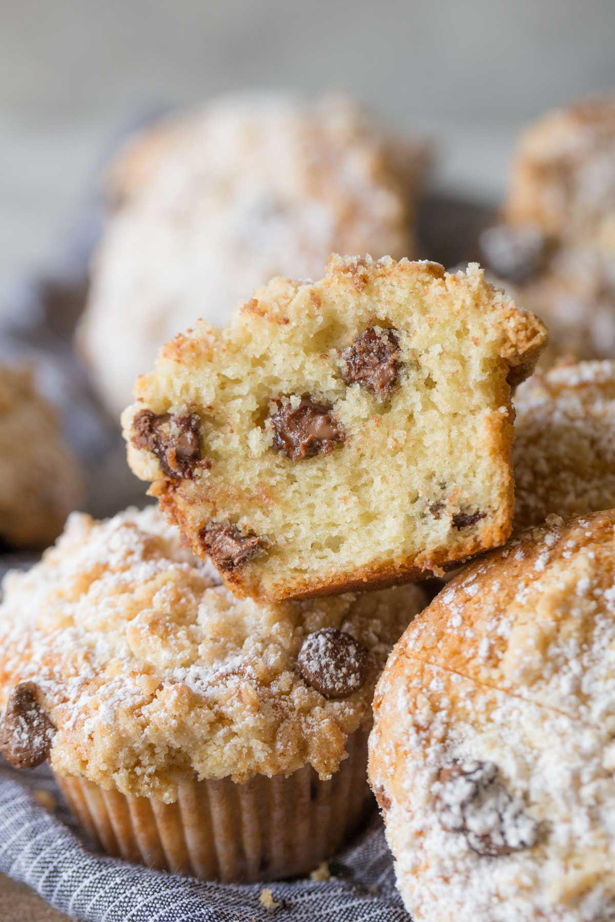 Close up of shot of Chocolate Chip Muffins with one muffin sliced open to show the inside texture. 