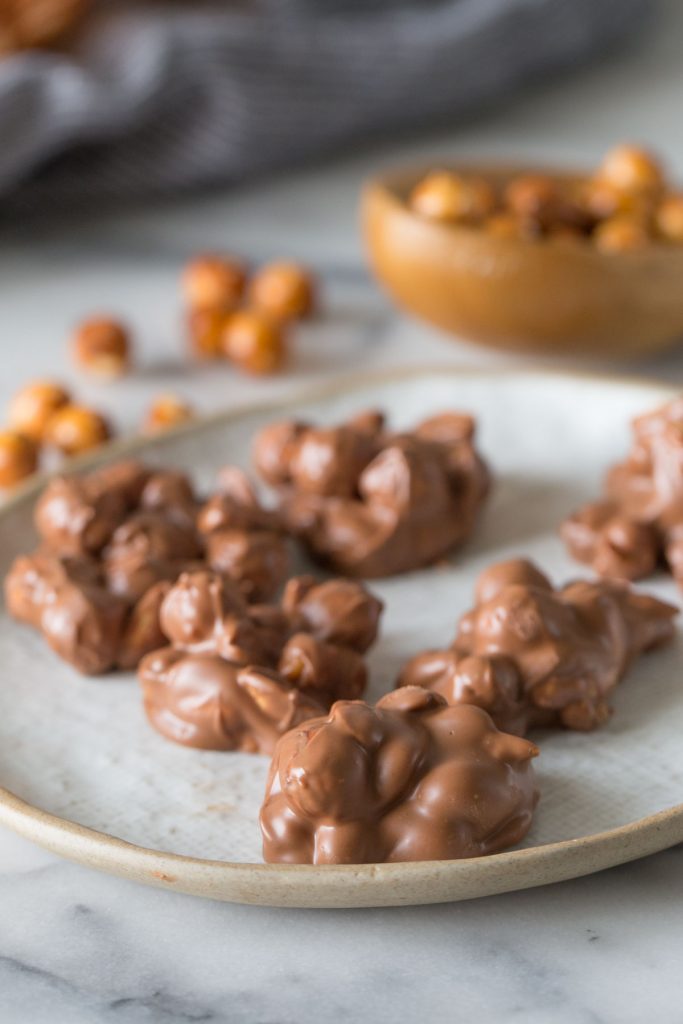 Close up shot of Chocolate Peanut Clusters on a plate.