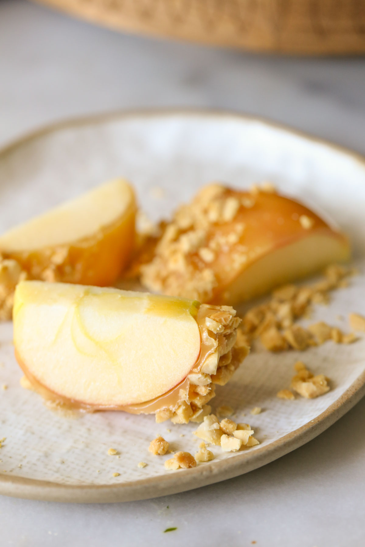 Close up shot of a sliced Homemade Caramel Apple on a plate.  