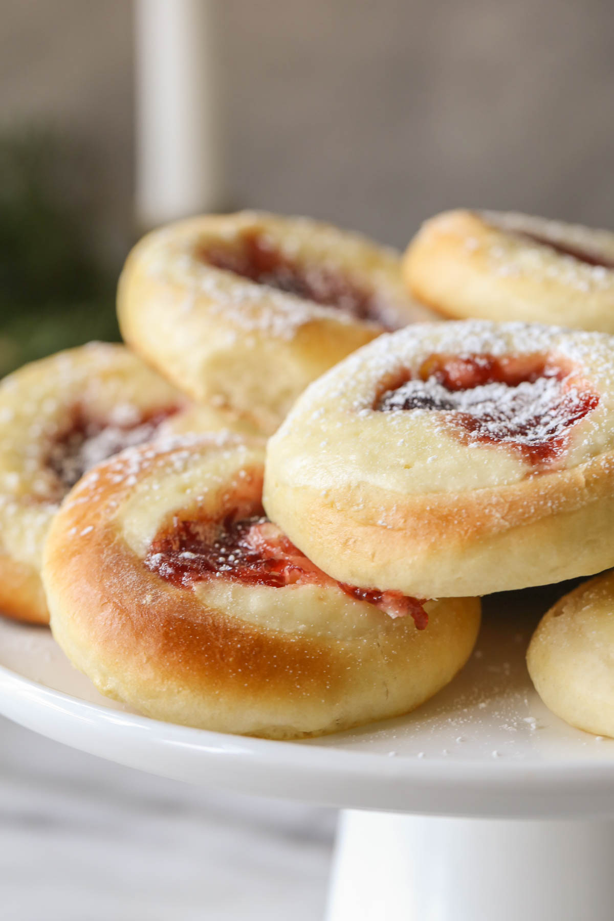 Close up shot of Raspberry Cream Cheese Kolaches arranged on a cake stand.  